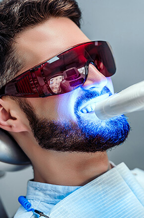 dental laser work in progress on a man's teeth