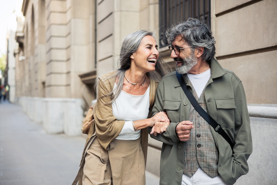 two seniors walking down the street smiling, restorative dentistry for seniors, dental care for seniors, Southwest Dental Care, Jefferson City MO, dentures, dental implants, gum disease treatment, oral health tips for seniors